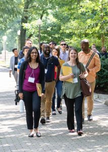 New faculty walking on path in Oak Grove